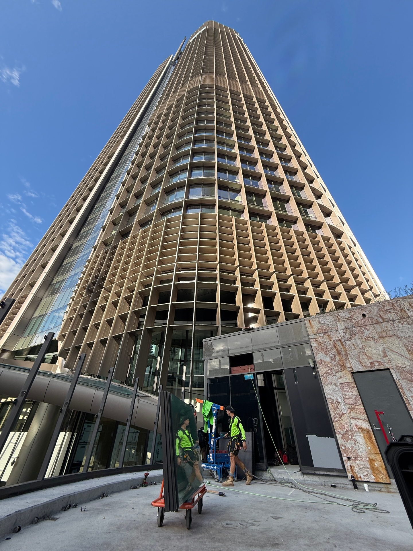 Looking up the curved bronze-louvred façade of 1 William Street tower in Brisbane CBD
