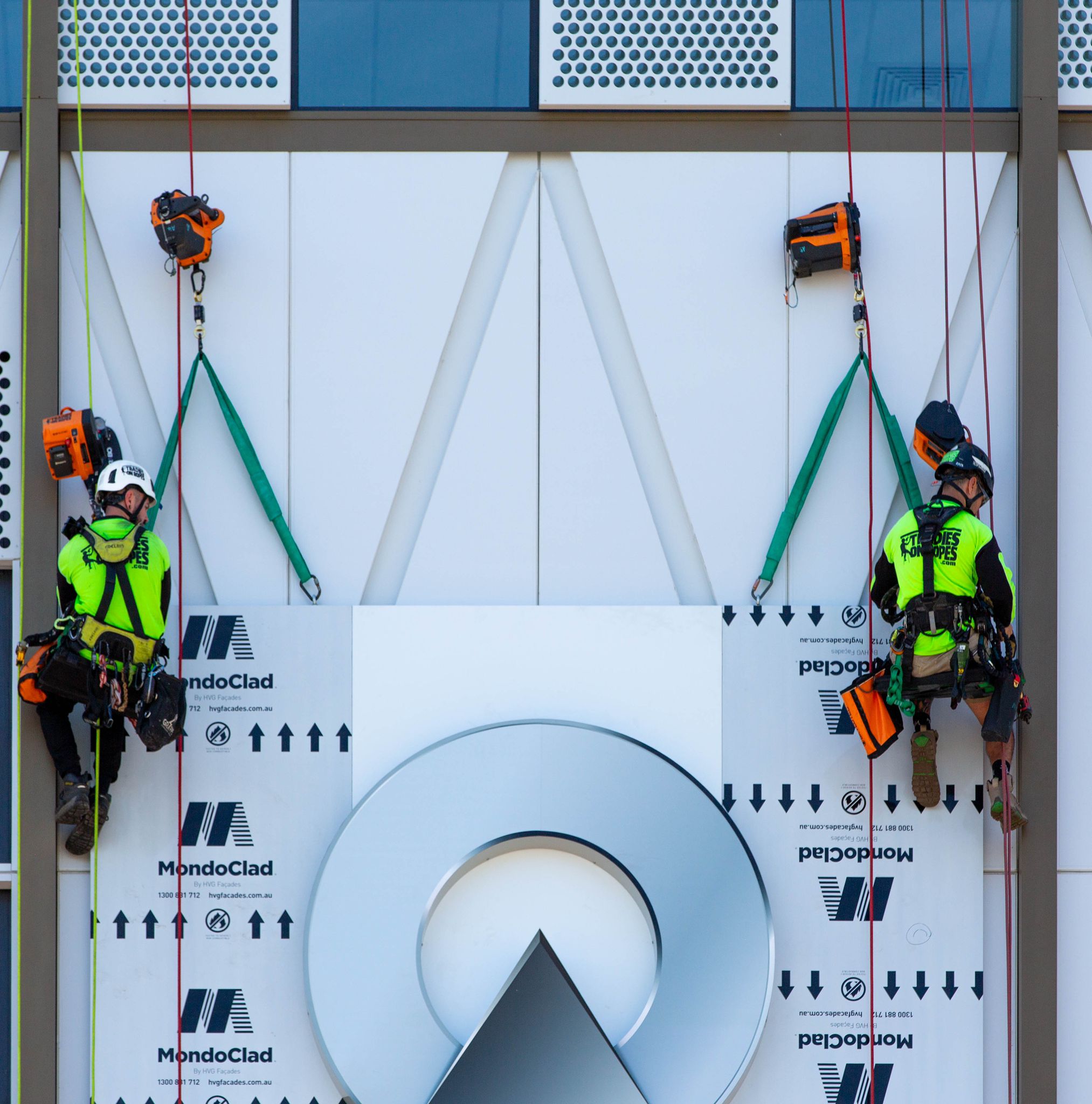 Tradies on Ropes technicians suspended beside MondoClad façade panels during installation works at Ascent on Bourke